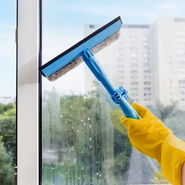 hand-in-yellow-glove-cleaning-window-with-squeegee-2026-01-09-10-53-58-utc