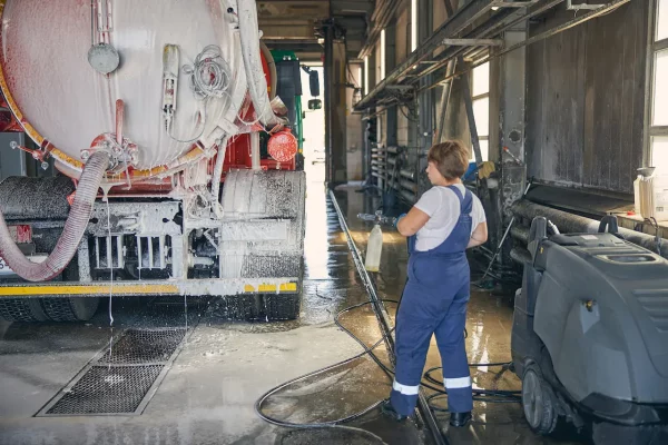 woman-washing-large-tanker-truck-indoors-2026-01-08-07-30-20-utc
